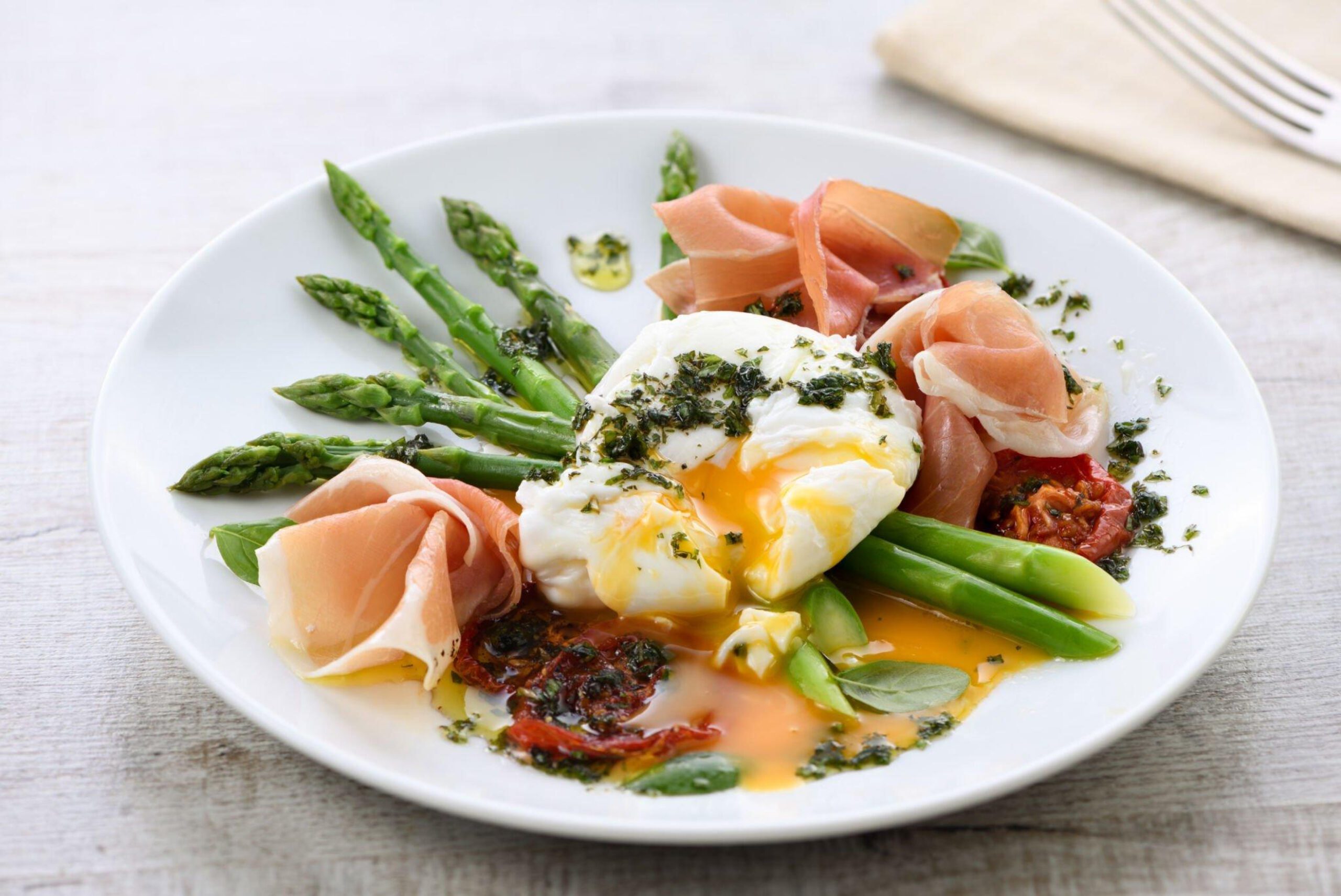 Best Eggs Benedict - Poached eggs with prosciutto, asparagus, sun-dried tomatoes and pesto